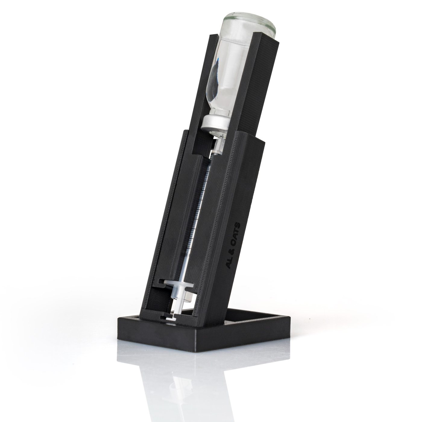 SteadyDraw fixture at a three-quarter angle with a vial and syringe loaded.