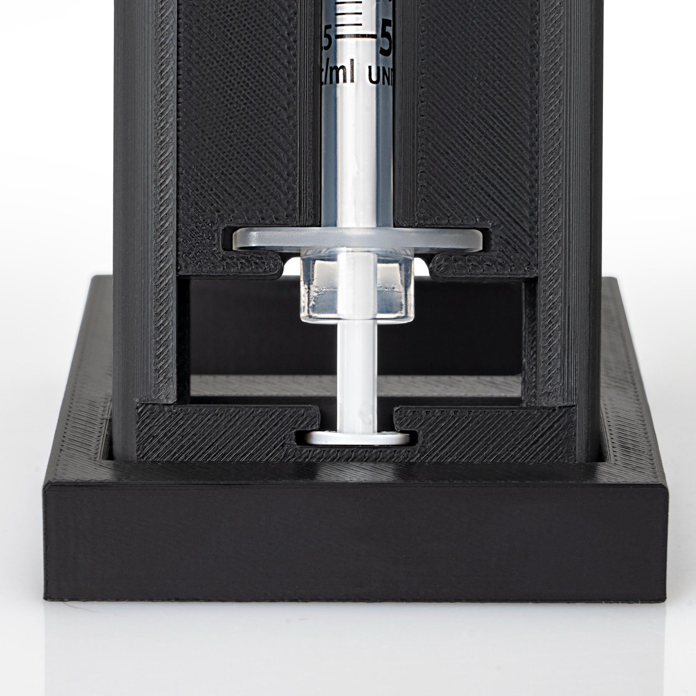 Close-up of the syringe flange held in the carriage.